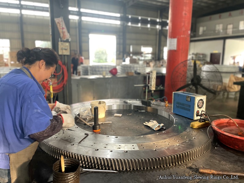 A large externally toothed slewing ring during final assembly and inspection